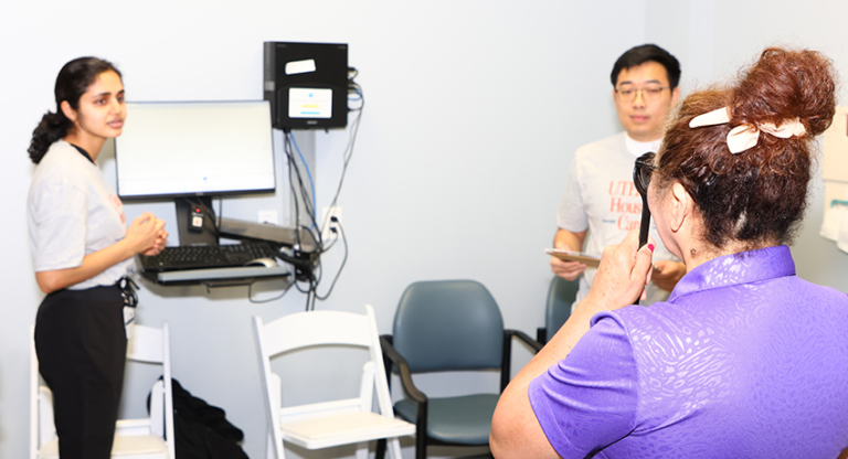 Patient taking an eye exam at the UTHealth Houston Cares health fair