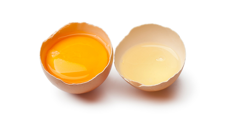 Egg yolk and white in a broken brown egg shell on white background